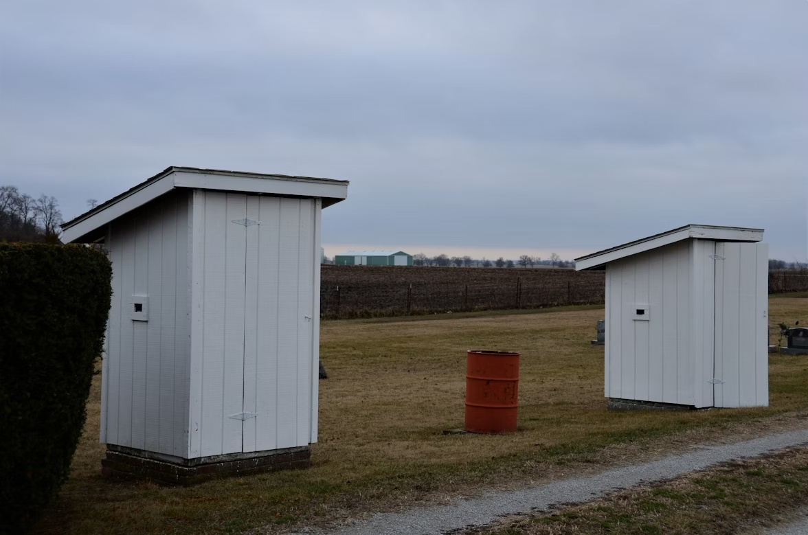 Small shelter units in an open field.